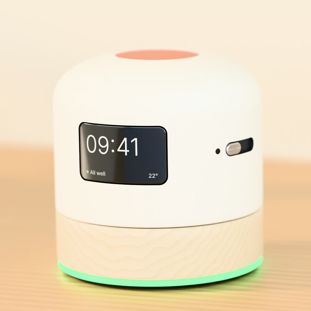 Concept render of the Mamori device: matte white ceramic body on a light wood base, a small lit screen showing 09:41 and All well, a mic shutter slider, an orange button on top and a green ring light at the base